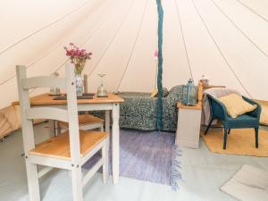 a room with a table and chairs in a tent at Bluebell in Hereford