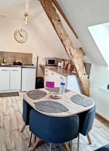 a kitchen with a table with a bottle of water on it at La Manch'hôtes in Domjean