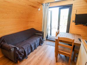 a living room with a couch and a table in a room at Gander Pod in Worcester