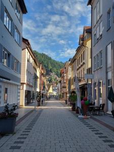 an empty street in a town with buildings at Apartement am Waldrand in Bad Wildbad