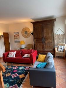 a living room with two couches and a couch at Gîte Casita - La Mailleraie in Gan