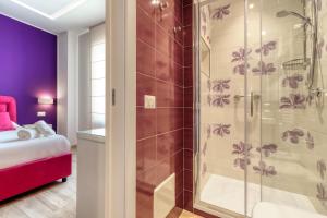 a bathroom with a shower with purple walls at Tiffany Suites in Sorrento