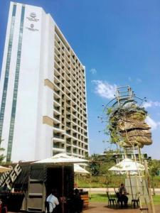 a tall white building with a large building at Menlyn Apartment - Studio in Pretoria