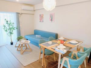 a living room with a table and a blue couch at Akasaka Residence in Tokyo