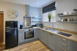a kitchen with a black refrigerator and a sink at Host & Stay - 82 Galgate in Barnard Castle