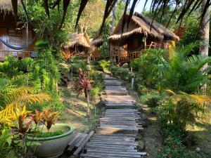 a wooden path in front of a resort at LITTLE EDEN Bungalows in Ko Chang