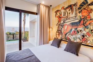 a bedroom with a mural on the wall at Grand Luxor Village in Benidorm