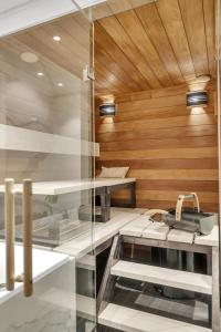 a sauna with wooden walls and a wooden ceiling at Kais sauna, jacuzzi, cinema and balcony house! Central location in Tromsø