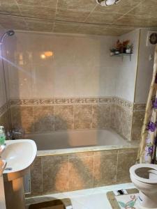 ein Badezimmer mit einer Badewanne, einem WC und einem Waschbecken in der Unterkunft Comfortable home in middle Atlas in Azrou