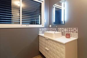 a bathroom with a white sink and a window at La birette in Vignoux-sur-Barangeon