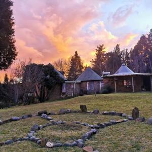 a rock garden in a yard with a house at Athanor Cottages in Hogsback