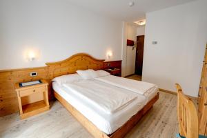 Postel nebo postele na pokoji v ubytování Hotel Garni Sottobosco