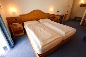 Postel nebo postele na pokoji v ubytování Hotel Garni Sottobosco