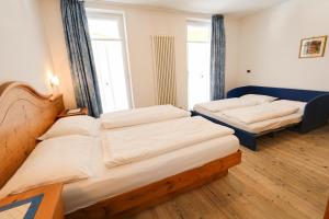 Postel nebo postele na pokoji v ubytování Hotel Garni Sottobosco
