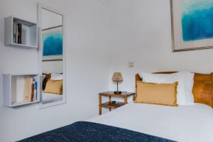 En eller flere senge i et værelse på Casinha do Paiol