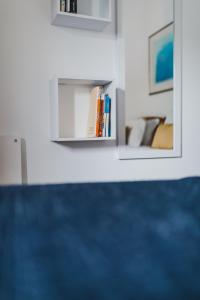 a room with a shelf with books and a couch at Casinha do Paiol in Porto da Cruz