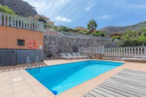 a swimming pool in front of a house at Fantastic Rural House with Pool and terrace in Santa Brígida