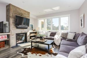 a living room with a couch and a fireplace at Wintergreen Haven 85574 in Blue Mountains