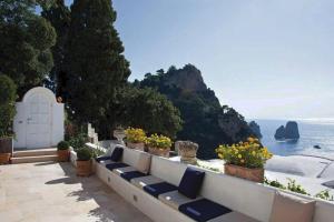 a view of the ocean from a balcony with flowers at Villa le stelle capri in Capri