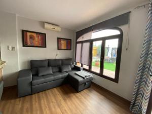 a living room with a couch and a window at Alojamiento rural RISMAR in Baza
