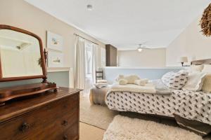 a bedroom with a bed with a dresser and a mirror at Elegant Sierra Lane Retreat 88780 in Blue Mountains