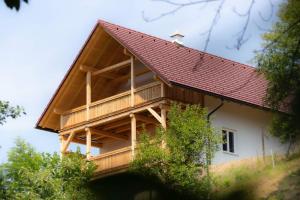 a house with a red roof on top of it at Ferienhaus Schilcherland in Hochneuberg +41 photos
