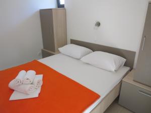 a small bedroom with a bed with towels on it at Camping Mia Bungalow & Mobile Home in Biograd na Moru