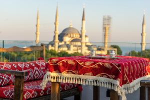 a table with a red table cloth with a mosque in the background at World Heritage Center Hotel in Istanbul