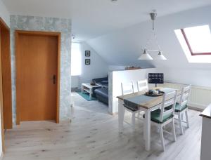 a kitchen and dining room with a table and chairs at Ferienwohnung Schöne Aussicht in Treben