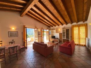 a living room with a table and red chairs at Appartamenti Apollo XI, GTSGroup in Tignale