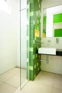 a bathroom with a sink and a glass shower at Prinsenhuis in Amsterdam