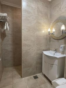 a bathroom with a sink and a toilet at Karikas Hotel in Hajdúszoboszló