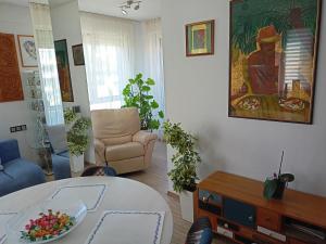 a living room with a table and a couch at Bright apartment at a great location in Sofia