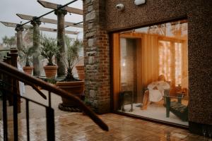 a woman sitting in a chair on a patio at The Rabbit Hotel & Retreat in Templepatrick
