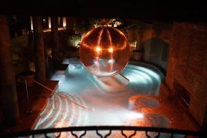 a swimming pool with a large metal ball on top of it at The Rabbit Hotel & Retreat in Templepatrick