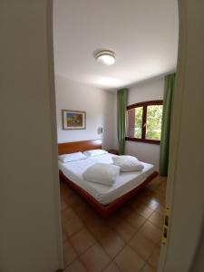 מיטה או מיטות בחדר ב-Aparthotel Ponza