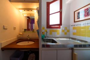 a small kitchen with a sink and a window at Aphrodite Villas Halki - Studio Rosa in Halki