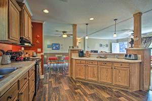 a kitchen with wooden cabinets and a counter top at Charming Claxton Home Private Deck and Fire Pit! in Claxton