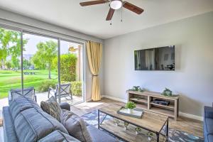 a living room with a couch and a ceiling fan at Golfers Paradise Condo in PGA West Golf Club! in La Quinta