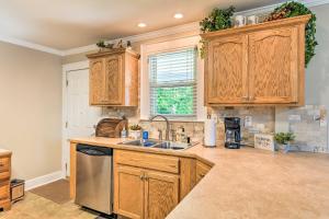 a kitchen with wooden cabinets and a sink at Belmont Retreat about 14 Mi to Dtwn Charlotte! in Belmont