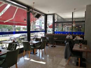 a restaurant with tables and chairs and a person sitting at a table at Nice Royal in Istanbul