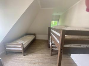 a room with two bunk beds in a attic at Kämmererhof - Inselperle in Fehmarn