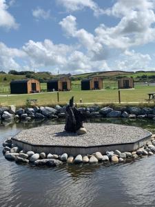 a statue in the middle of a body of water at Castledarcy Glamping in Lahinch
