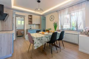 a kitchen and dining room with a table and chairs at Apartments Milica in Crikvenica