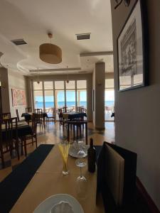 a dining room with a table with a view of the ocean at Joel Residence in Durr&euml;s