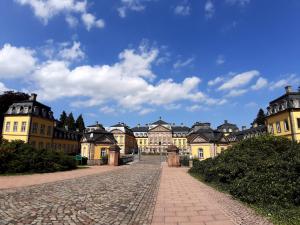 a cobblestone street in front of a large building at Twistesee Ferienwohnung in Bad Arolsen