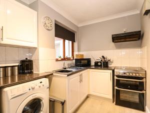 a kitchen with a washer and a dishwasher at Sandpiper Court in Great Yarmouth