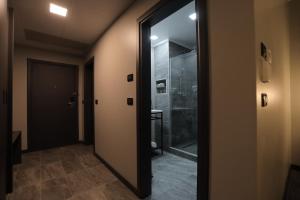 a bathroom with a glass door leading to a shower at Fiesta Royale Hotel in Accra