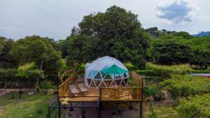 a tree house with an umbrella on a playground at Glamping Girardot & Hotel Puerta Del Sol Girardot in La Virginia