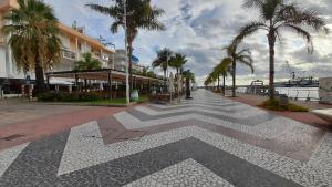 a walkway with a geometric design on the ground at Piso Casa Reina Un lugar cerca del mar y el puerto in Gandía